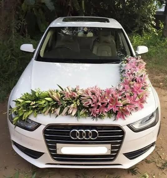 Wedding car decorated with flowers for bride and groom transport